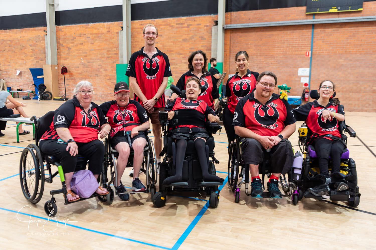 The Redlands Rebels team in red and black jerseys on court
